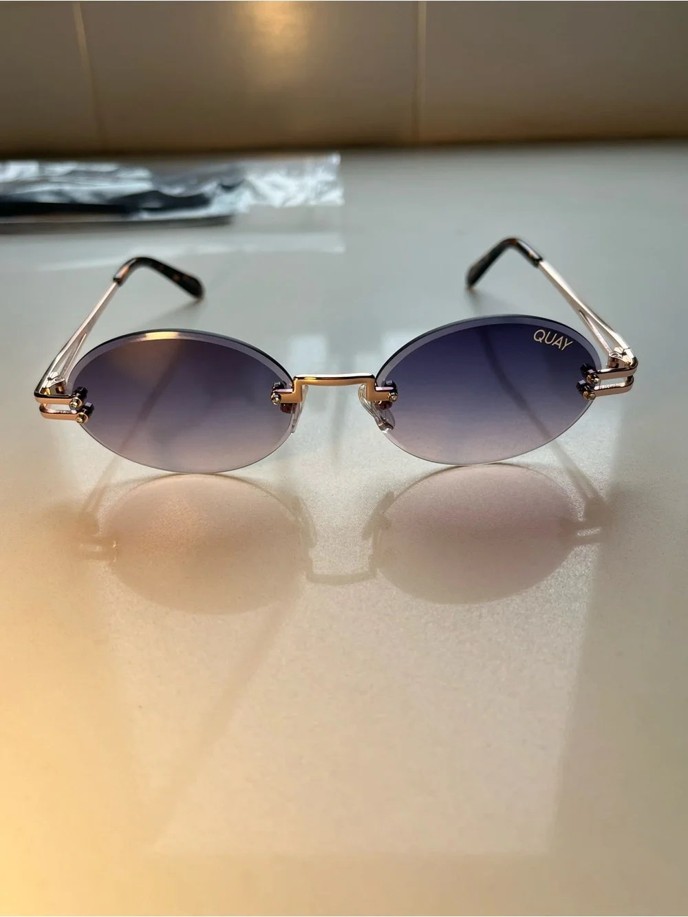 QUAY Literally Obsessed Rimless Oval Sunglasses-Rose Gold/Blue Pink Fade Lens